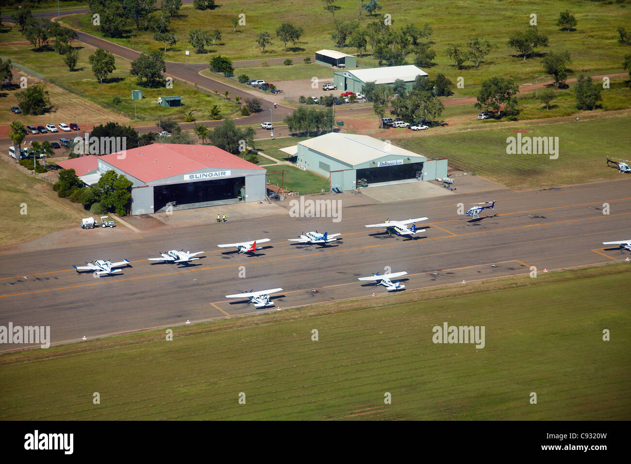 Planes and helicopter at Kununurra Airport, Kununurra, Kimberley Region, Western Australia, Australia - aerial Stock Photo