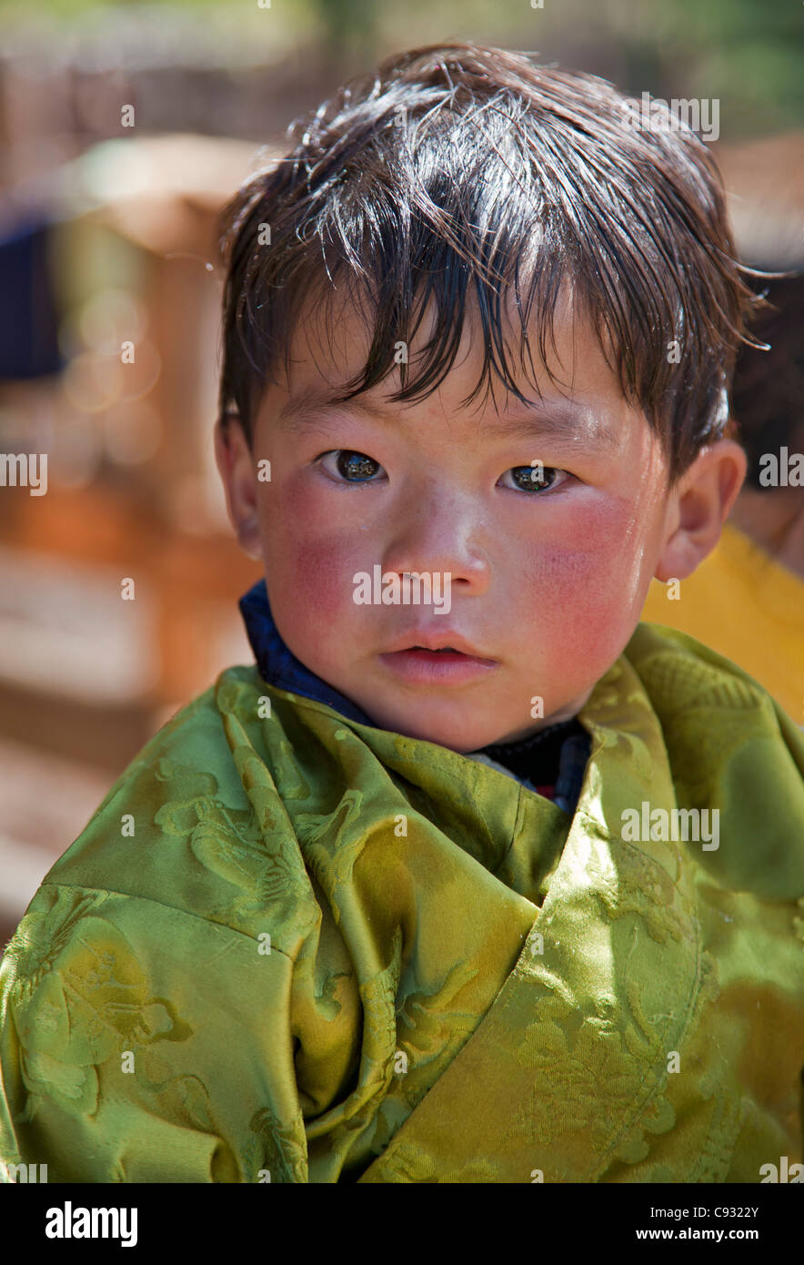 A young Bhutanese boy wearing the traditional male attire called gho. Stock Photo