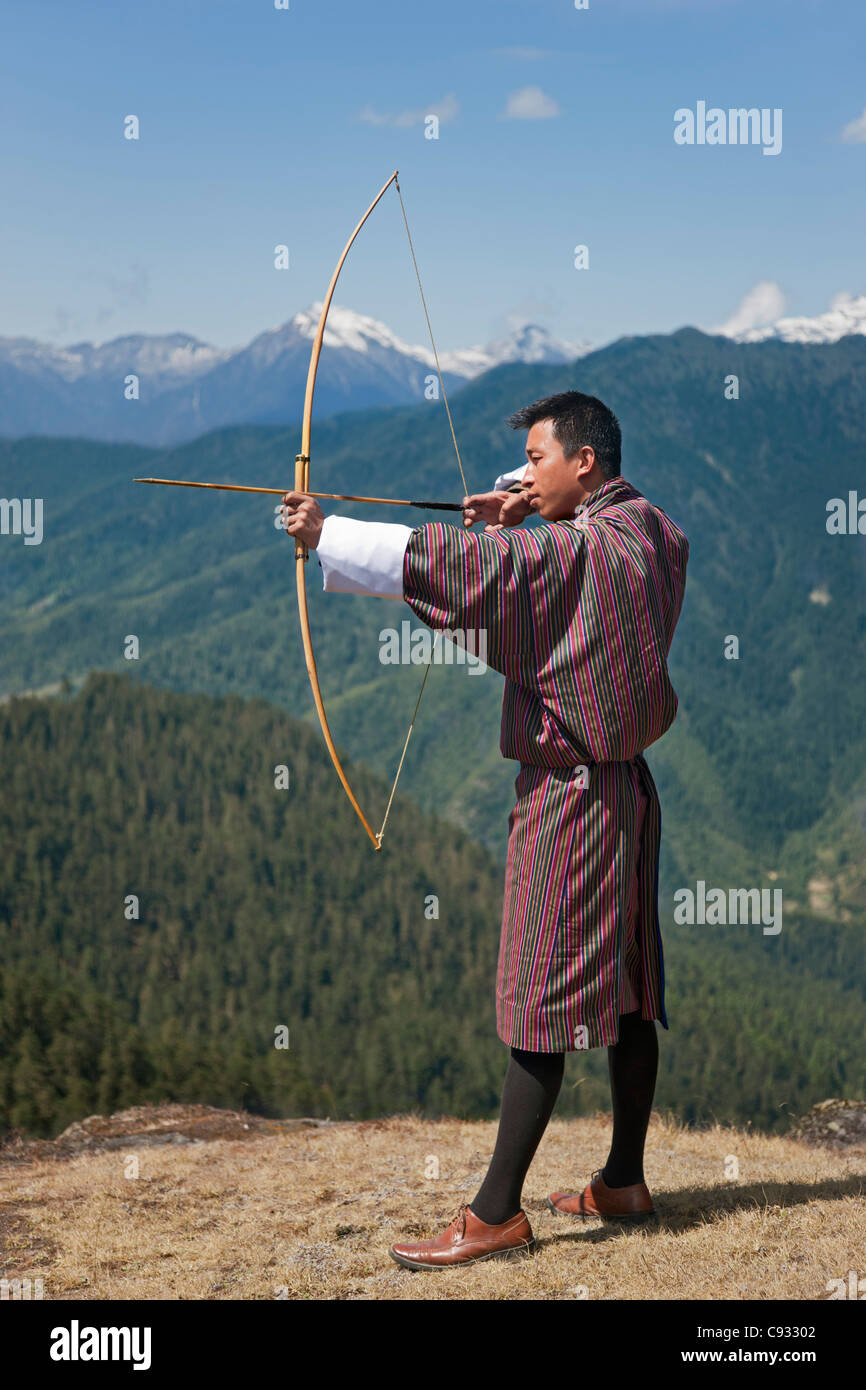 Archery, datse, is a favourite national sport of the Bhutanese. Here an Archer practices his skills on the high Cheli La Pass. Stock Photo
