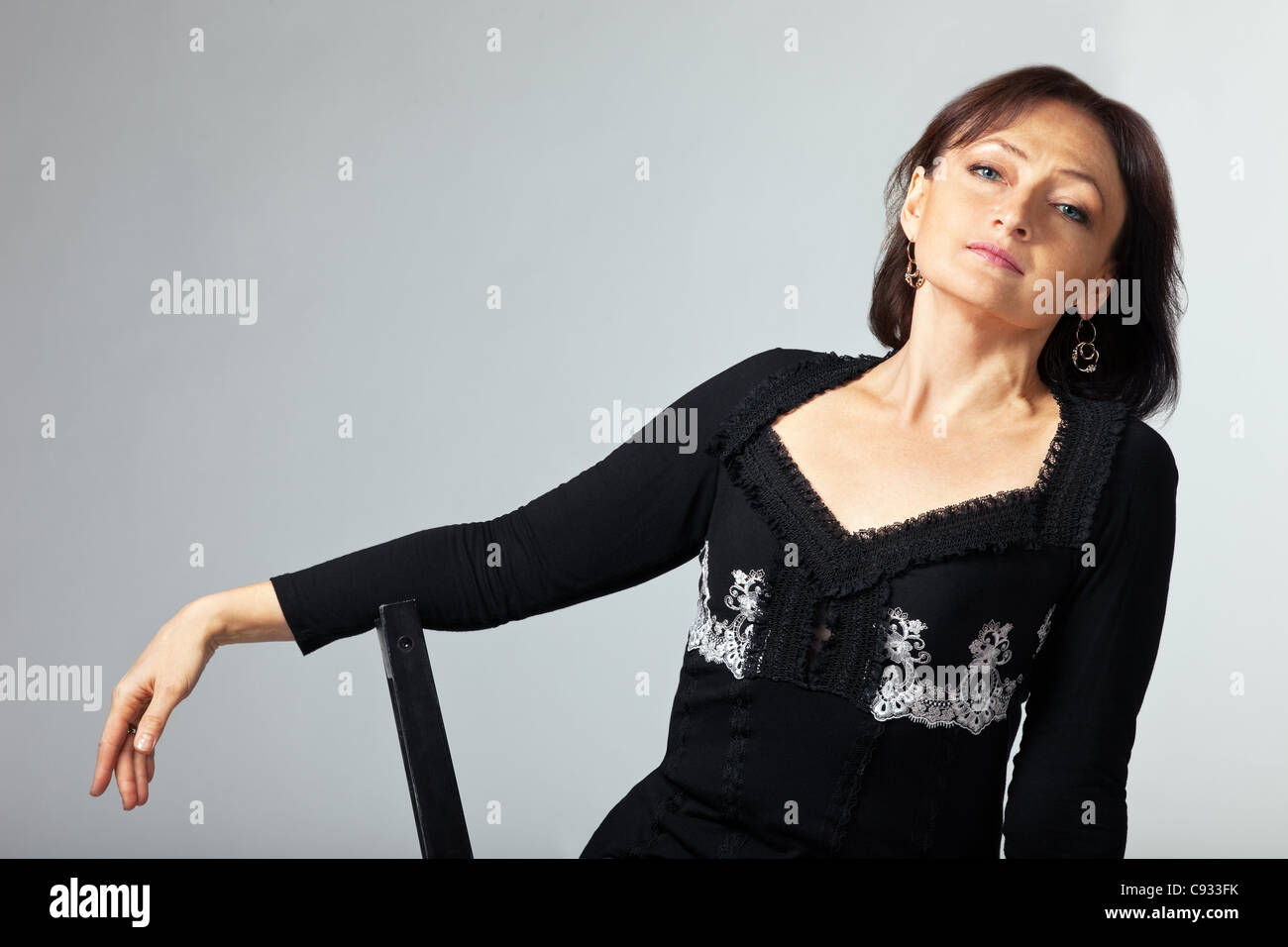 mature woman sit and relax on chair in lace jacket Stock Photo - Alamy