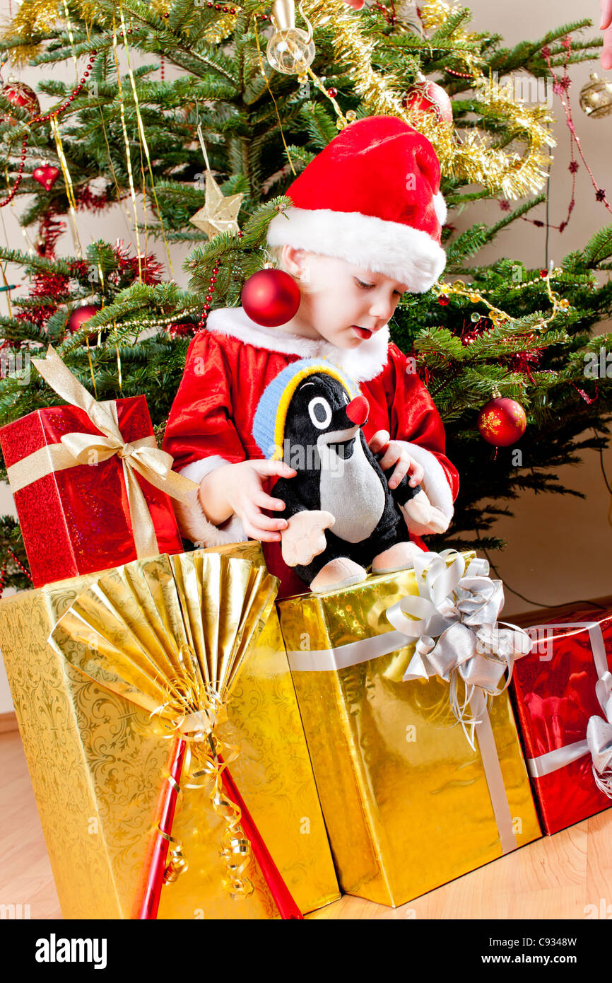 little girl as Santa Claus with Christmas presents Stock Photo - Alamy