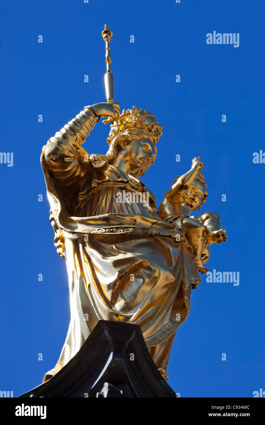 Gold statue of Our Lady on the top of the Marian Column in the Marien Platz, Munich, Bayern, Germany. Stock Photo