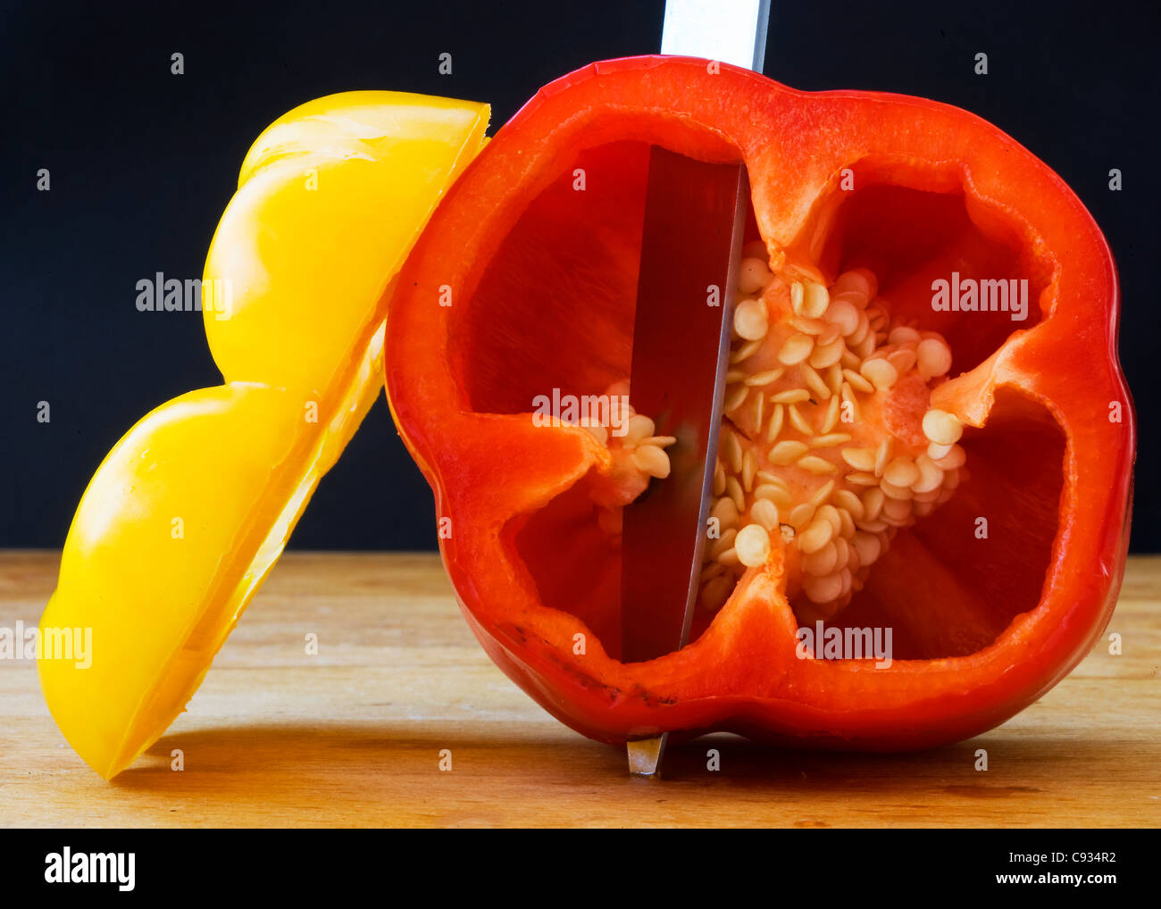 Yellow and Red Peppers on a Chopping Board Stock Photo - Alamy