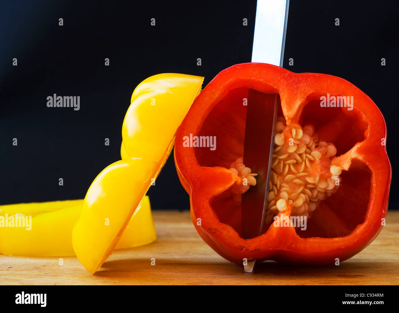 Yellow and Red Peppers on a Chopping Board Stock Photo - Alamy