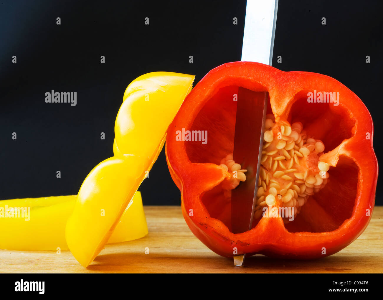 Yellow and Red Peppers on a Chopping Board Stock Photo - Alamy