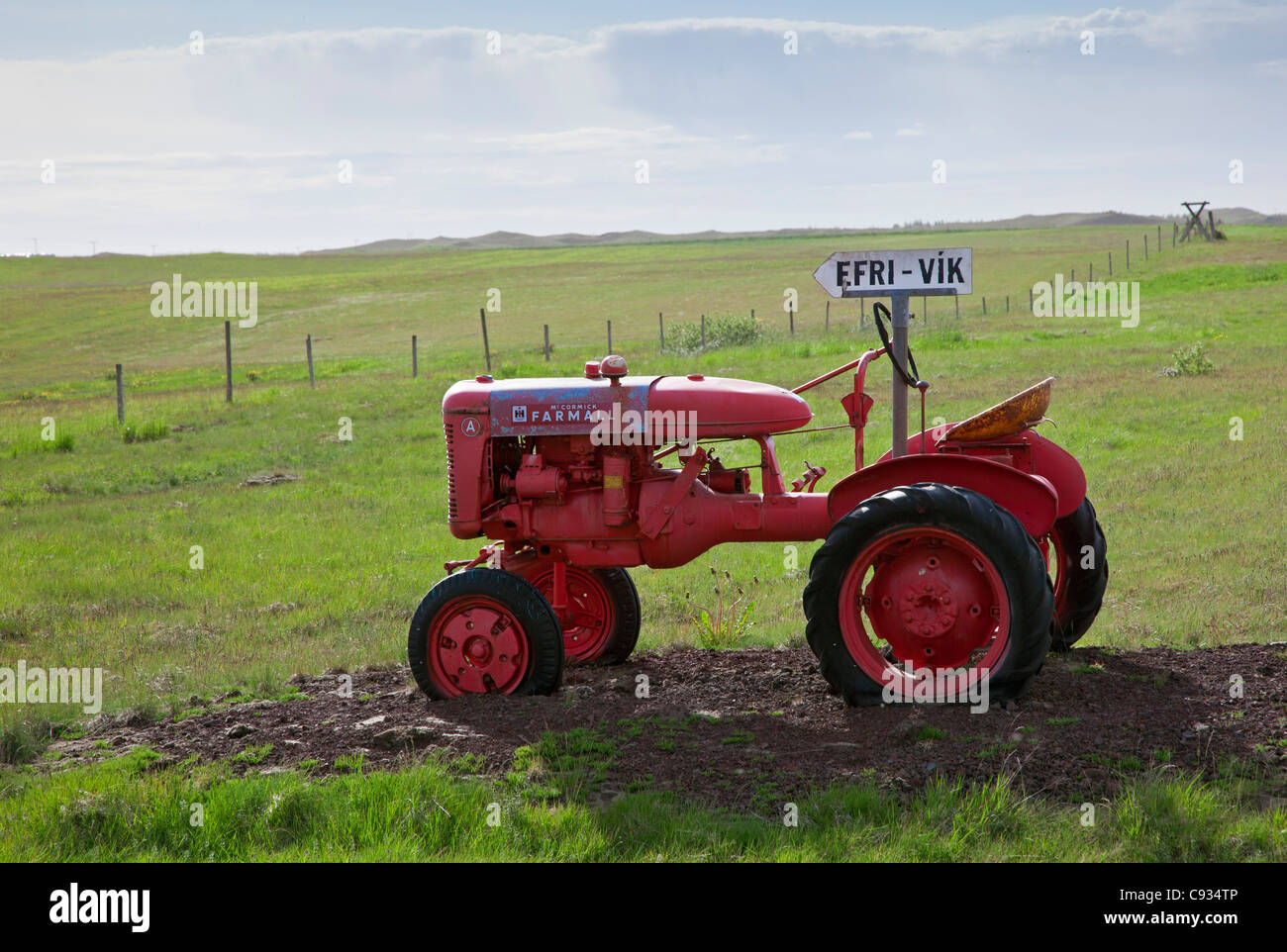 A small Farmall tractor made just before World War 11 has been turned into an unusual road sign to Efrivik. Stock Photo