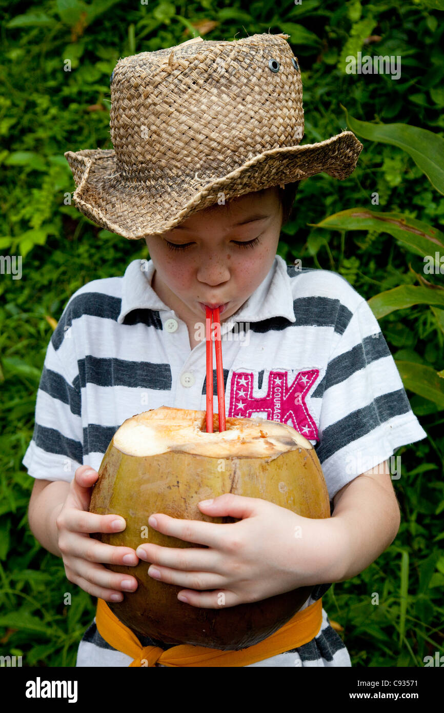 Bali, Ubud. A young tourist tries to drink his weight in coconut water. MR  Stock Photo - Alamy