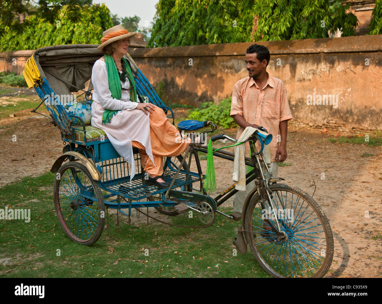 A tourist riding in a bicycle rickshaw at Chinsurah.. Stock Photo