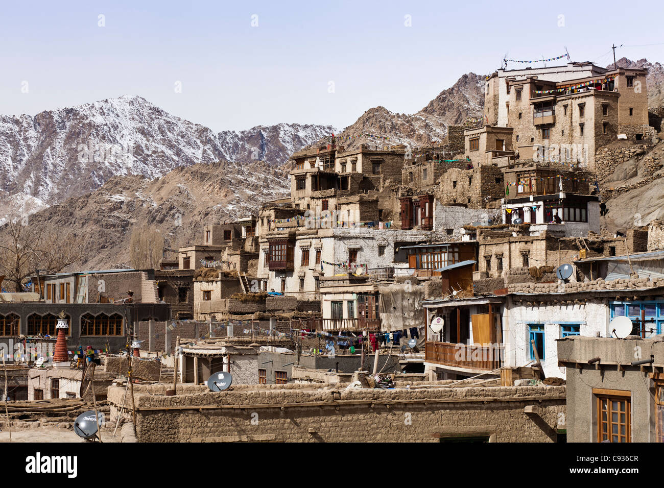 India, Ladakh, Leh. Houses in Leh, crowding up the hillside, a warren of crumbling buildings and irregular alleys. Stock Photo