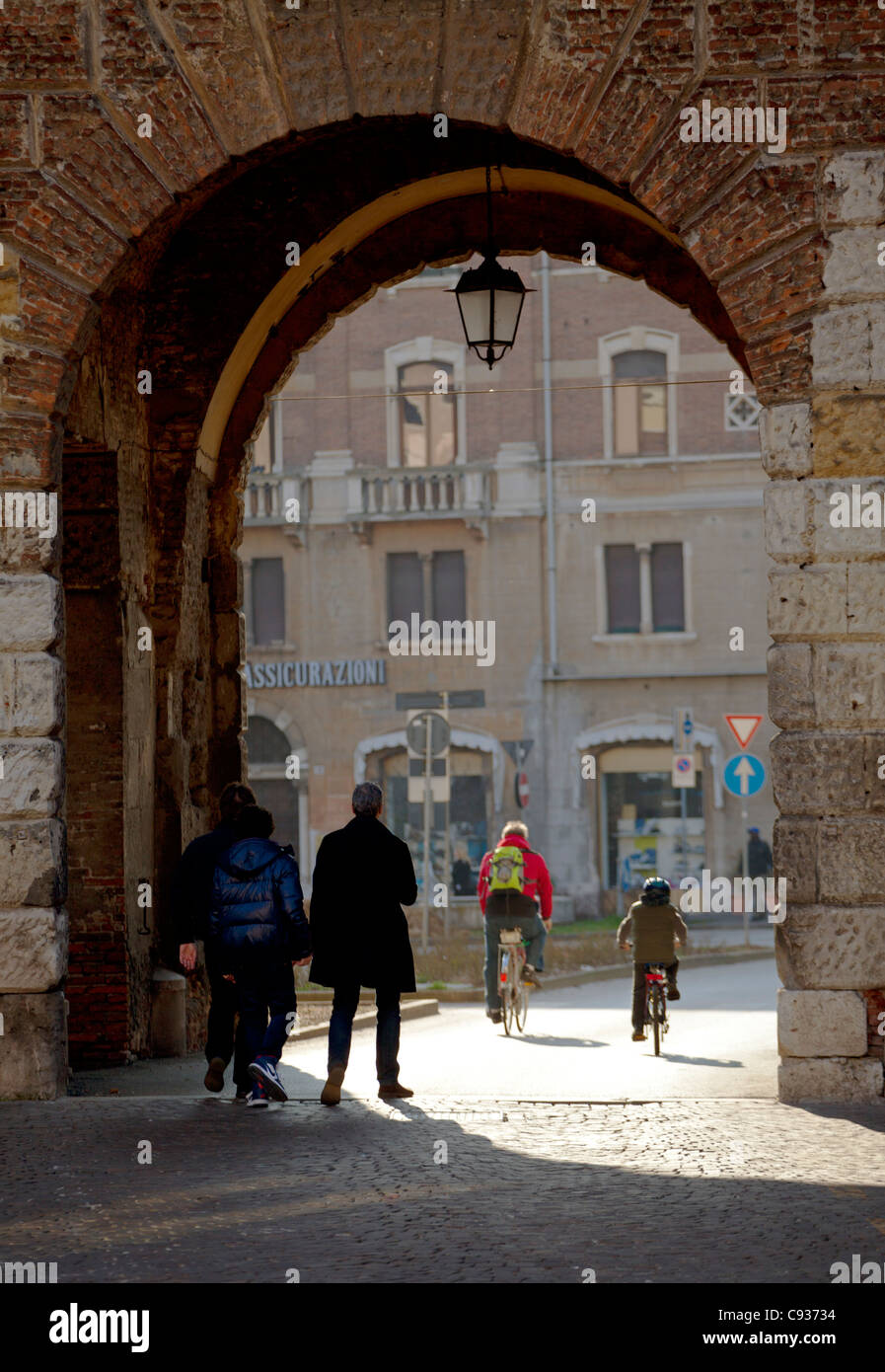 Italy, Veneto, Vicenza, People walking through the main gate 'Porta Castello'. Stock Photo