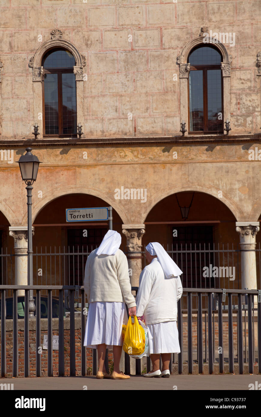 Italy, Veneto, Vicenza, Two nuns from a Catholic religious order stand on a bridge Stock Photo