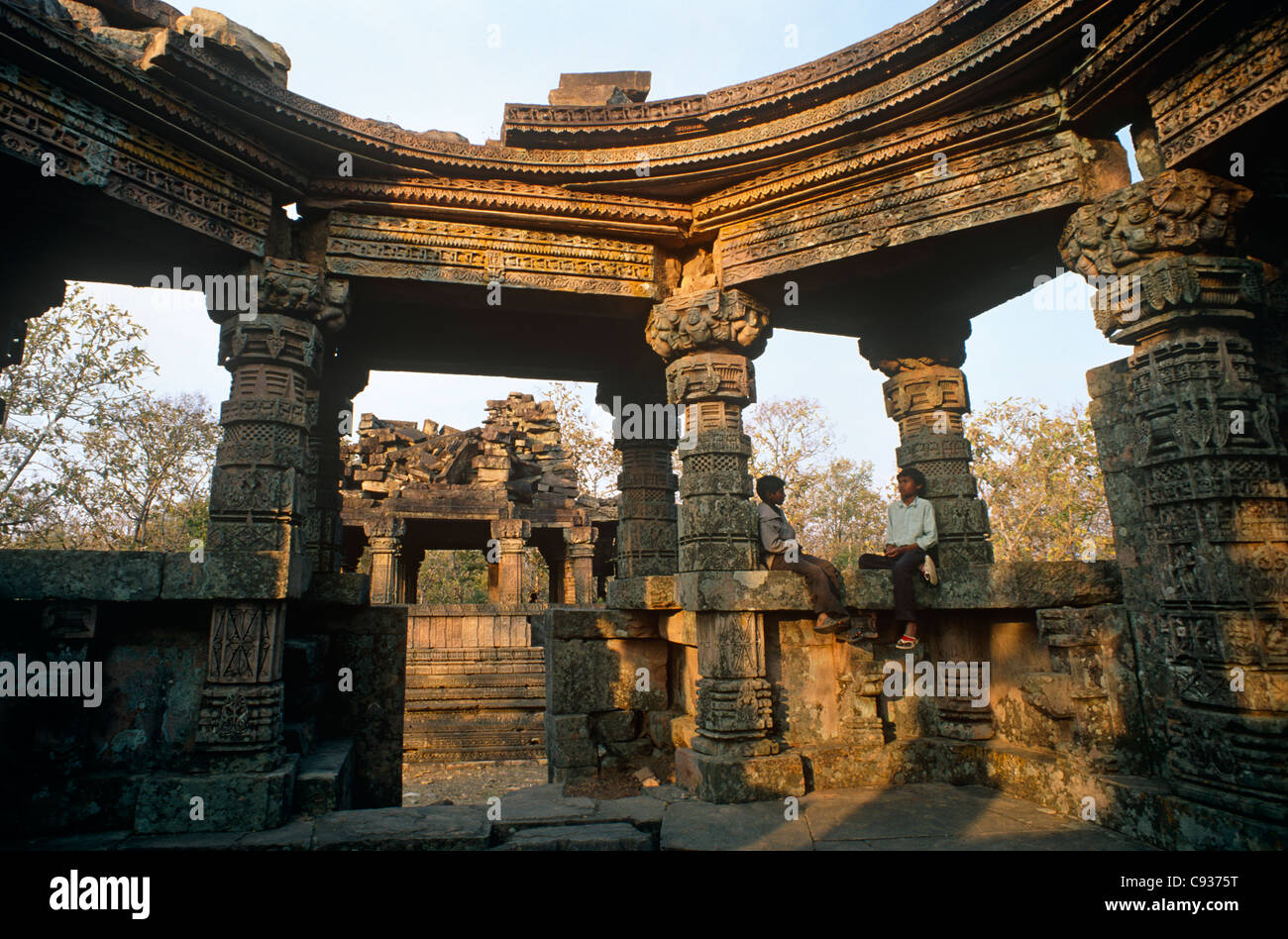 India, Madhya Pradesh, Ajaigarh. Young boys rest in the ruins of an ancient Hindu temple. Stock Photo