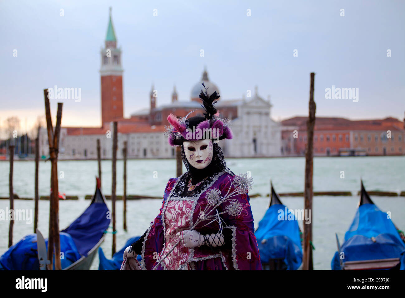 Venice, Veneto, Italy; A masked character on the 'Bacino di San Marco' during Carnival Stock Photo