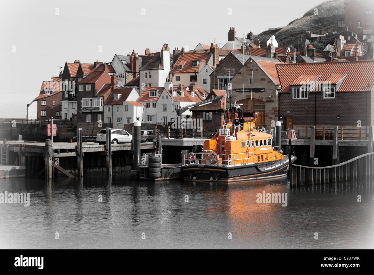 Whitby by the sea, with the boats at the docks and dockyard showing the beautiful views with the lifeboat in the distance. Stock Photo