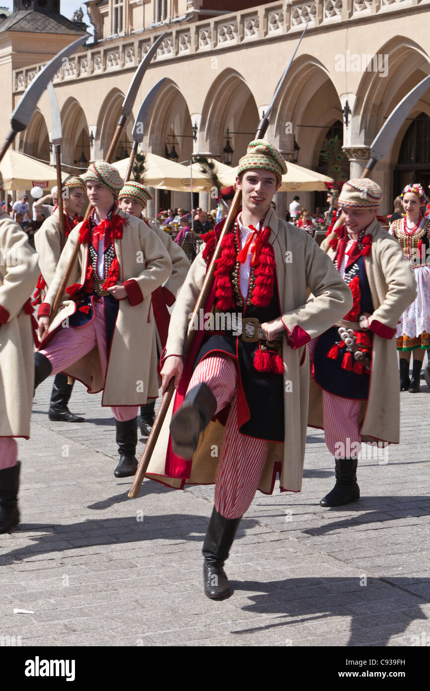 Poland, Cracow. Polish boys in traditional dress dancing in Market Square. Stock Photo