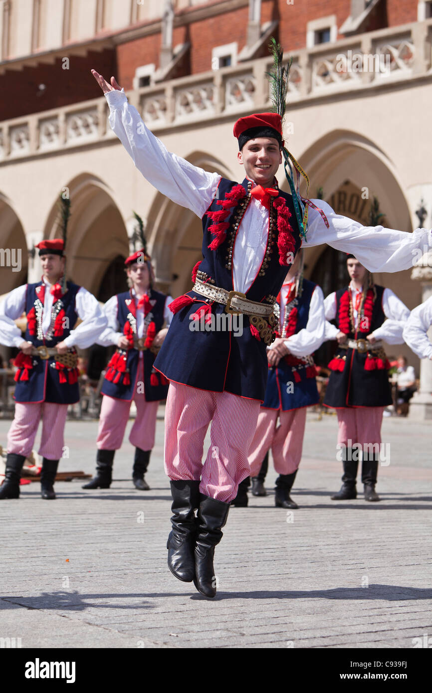 Poland, Cracow. Polish boys in traditional dress dancing in Market Square. Stock Photo