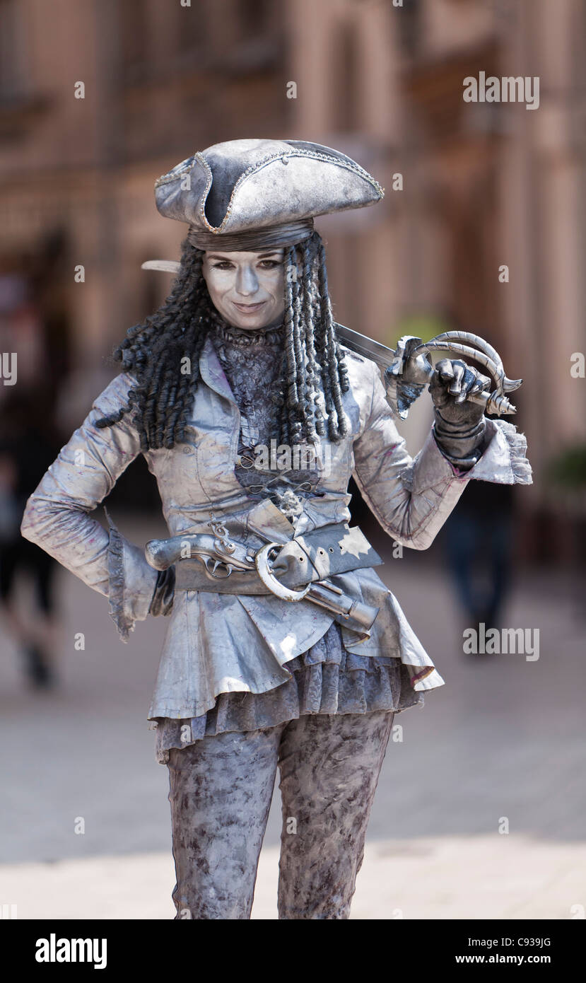 Poland, Cracow. A street entertainer in Market Square, painted entirely in silver paint. Stock Photo
