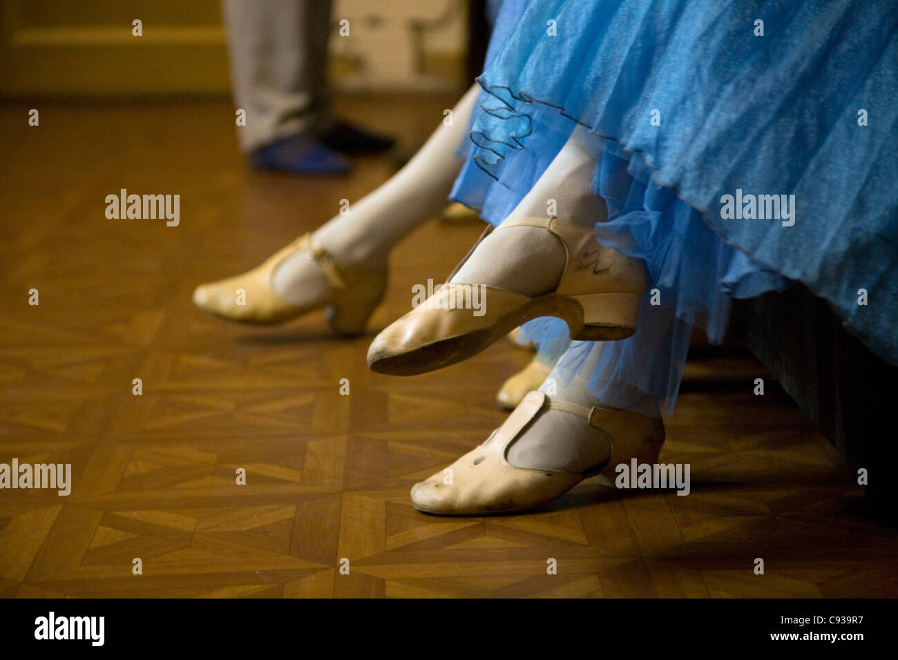 St.Petersburg, Russia; Detail of ballerinas shoes and dress during a short rest backstage Stock Photo