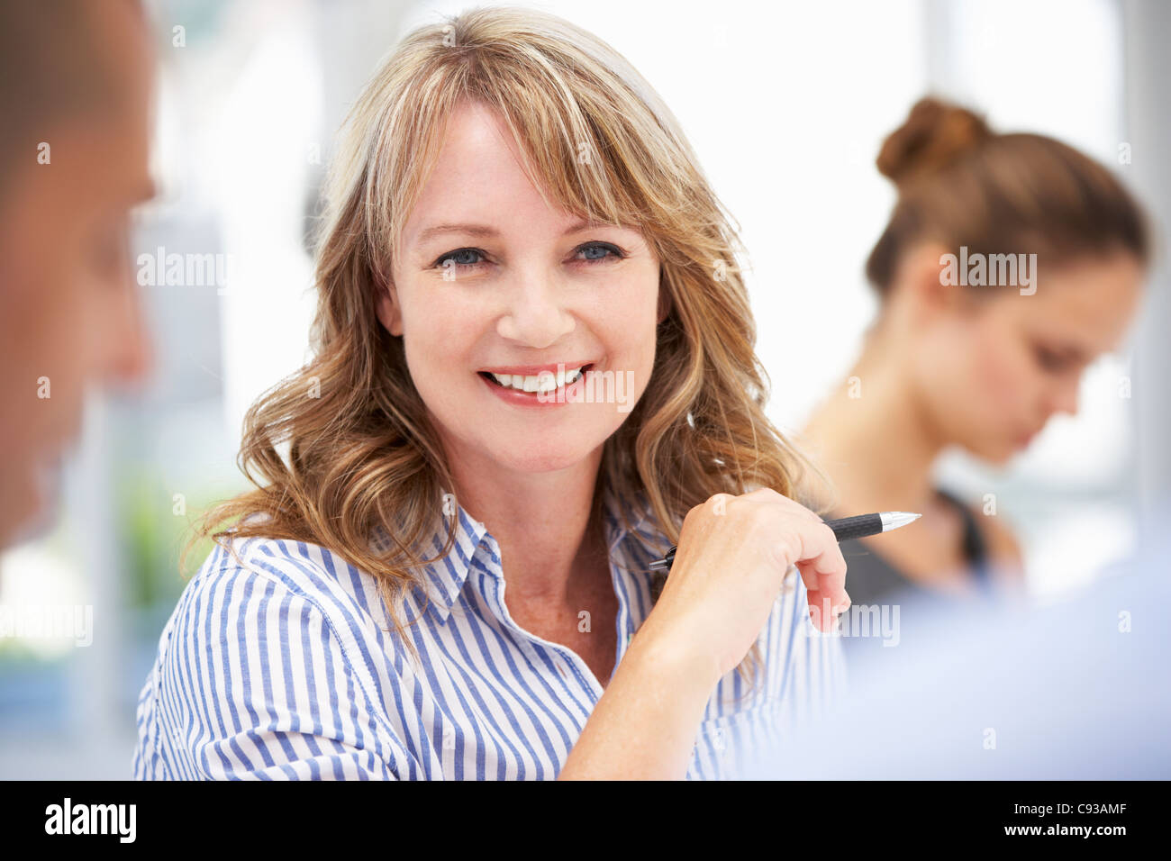 Mid age businesswoman in meeting Stock Photo