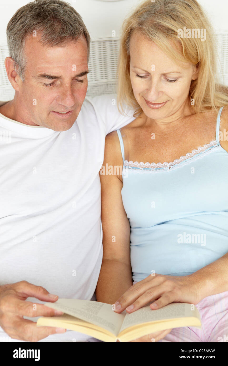 Mid age couple reading together Stock Photo