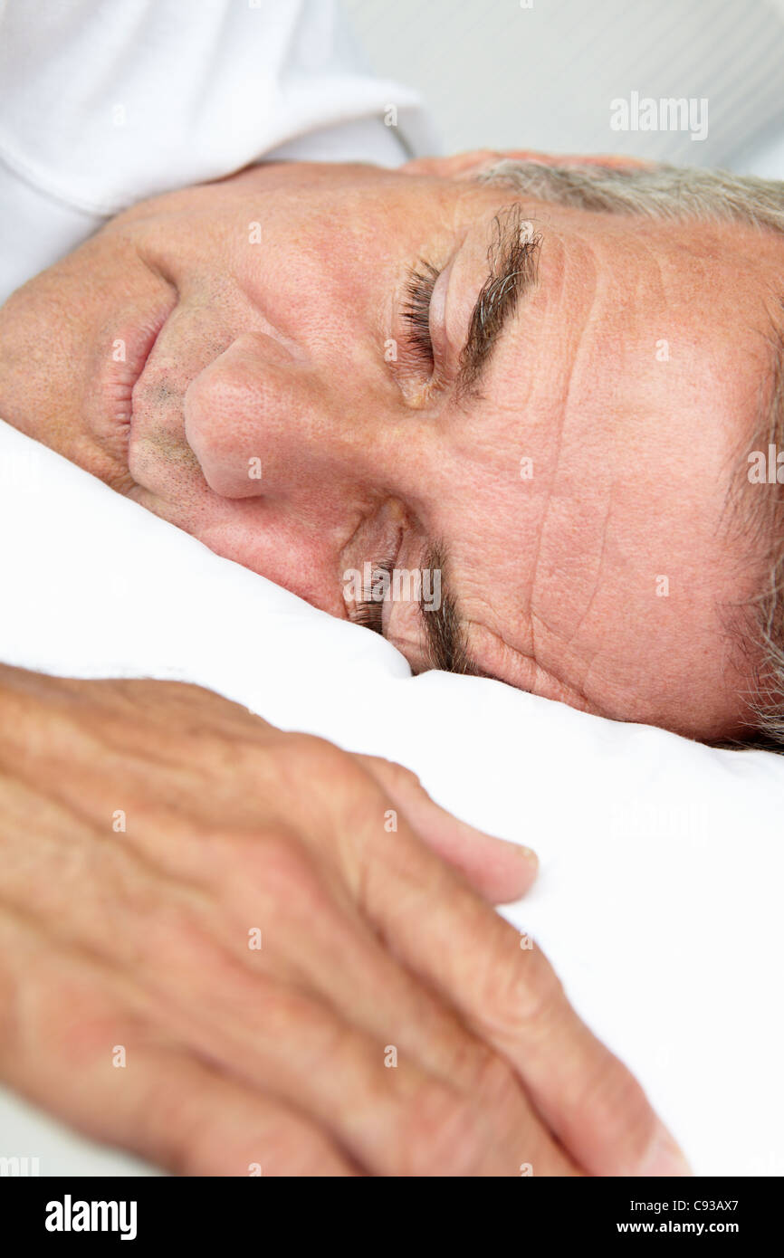 Head and shoulders mid age man sleeping Stock Photo