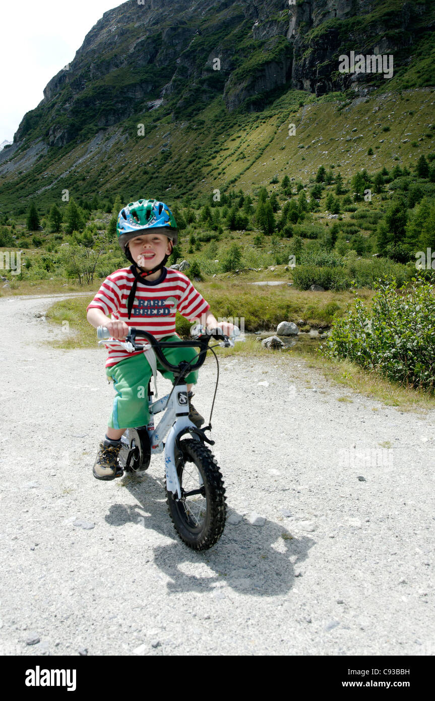 A young boy riding a bike Stock Photo - Alamy