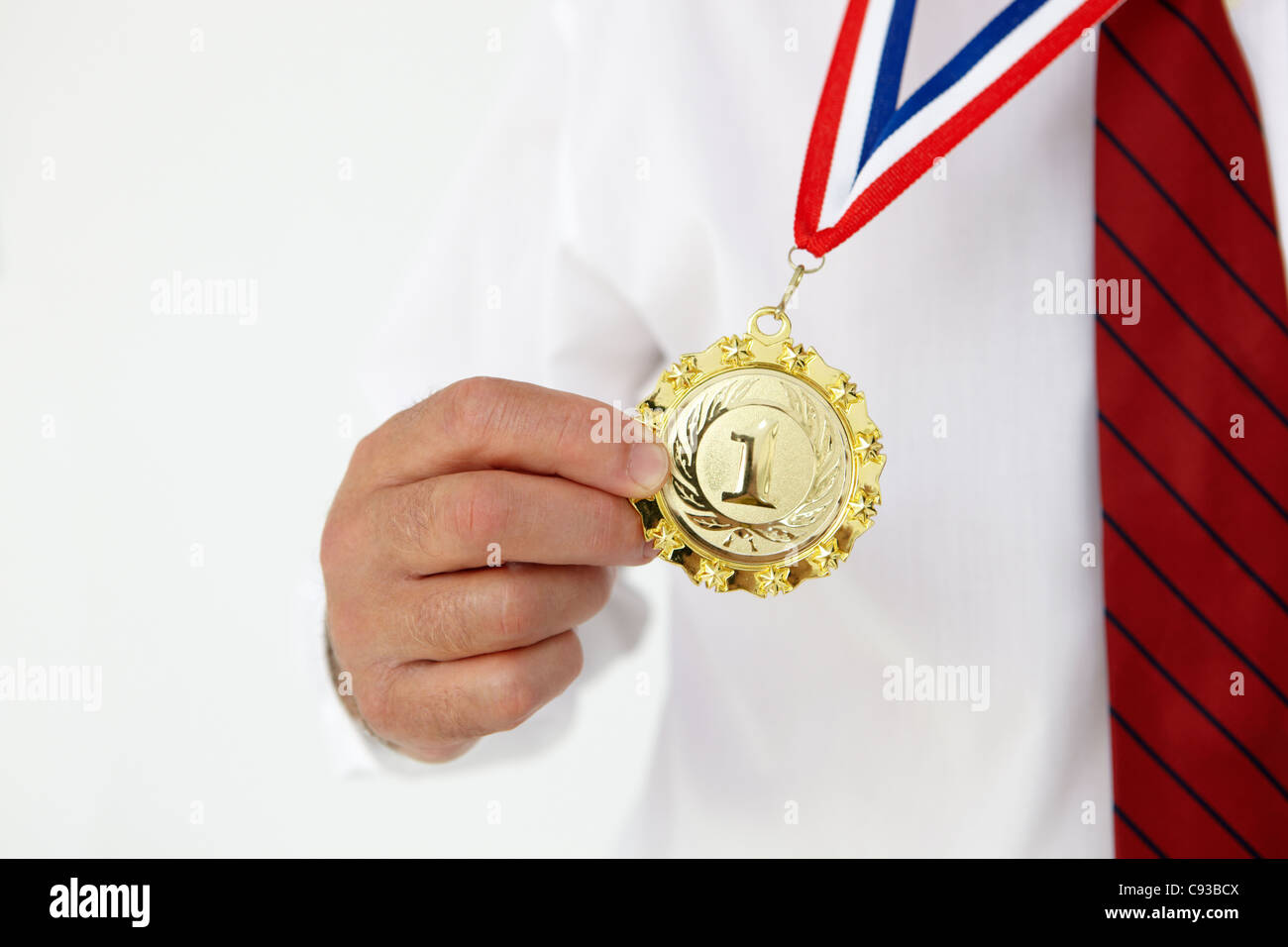 Businessman wearing medal Stock Photo