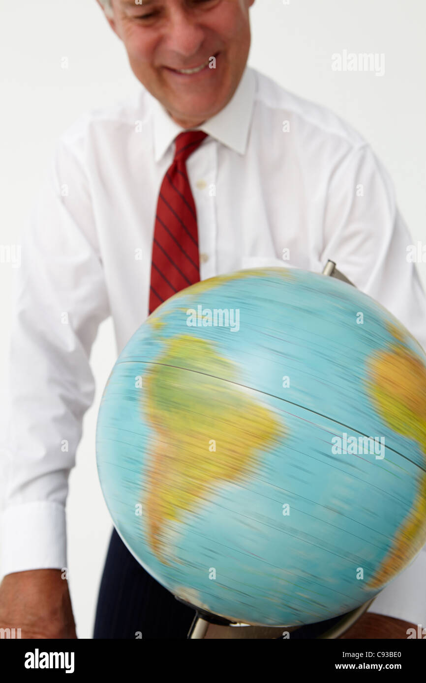 Senior Businessman Spinning Globe Stock Photo Alamy