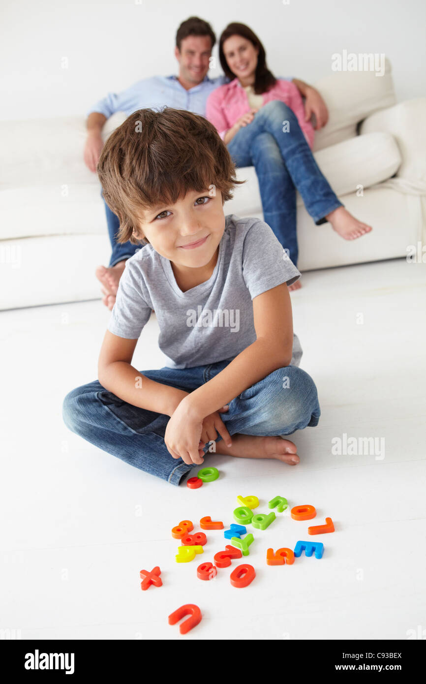 Parents watching son play Stock Photo