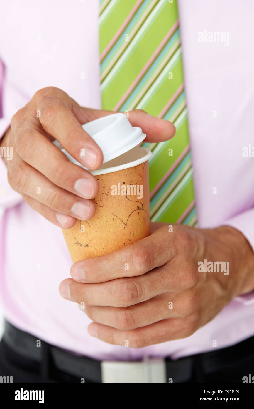 Businessman holding takeout coffee Stock Photo