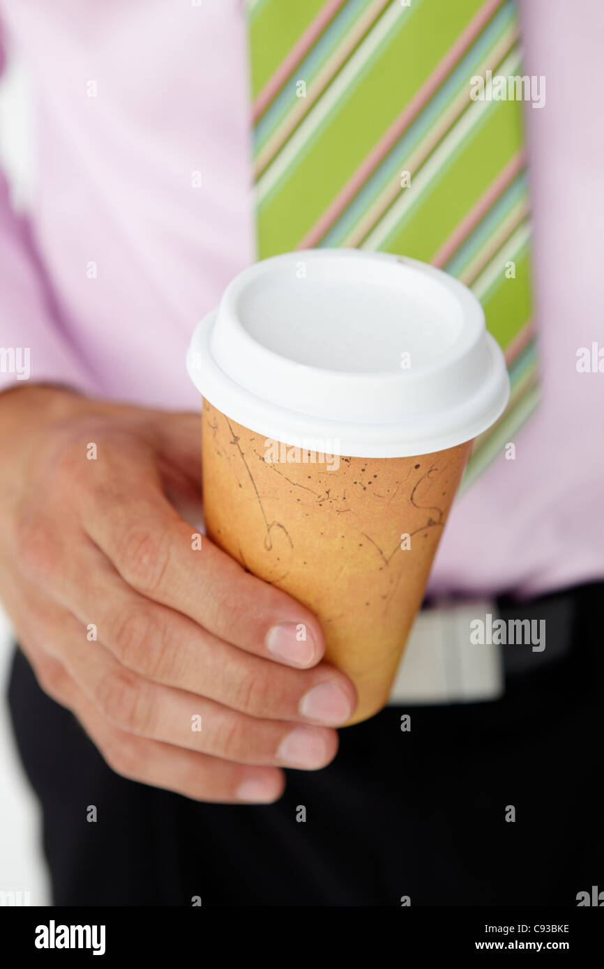 Businessman holding takeout coffee Stock Photo