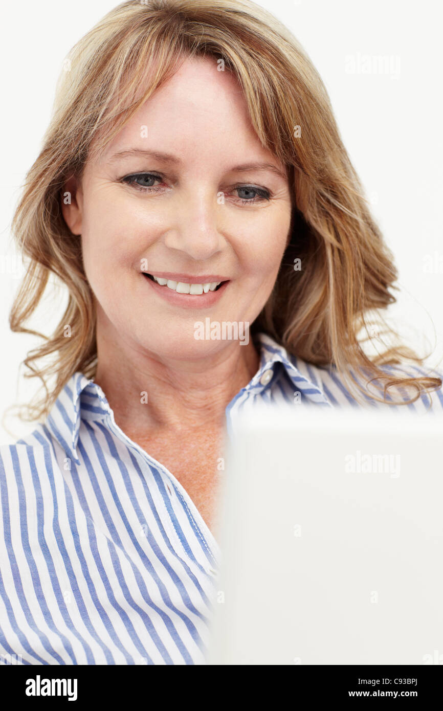 Mid age businesswoman using laptop Stock Photo