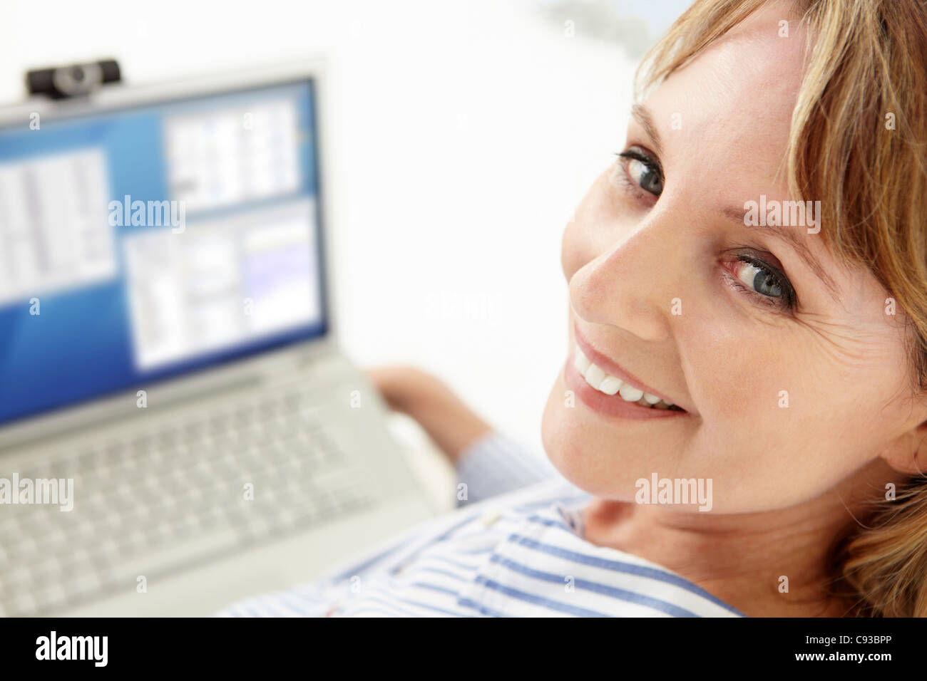Mid age businesswoman using laptop Stock Photo
