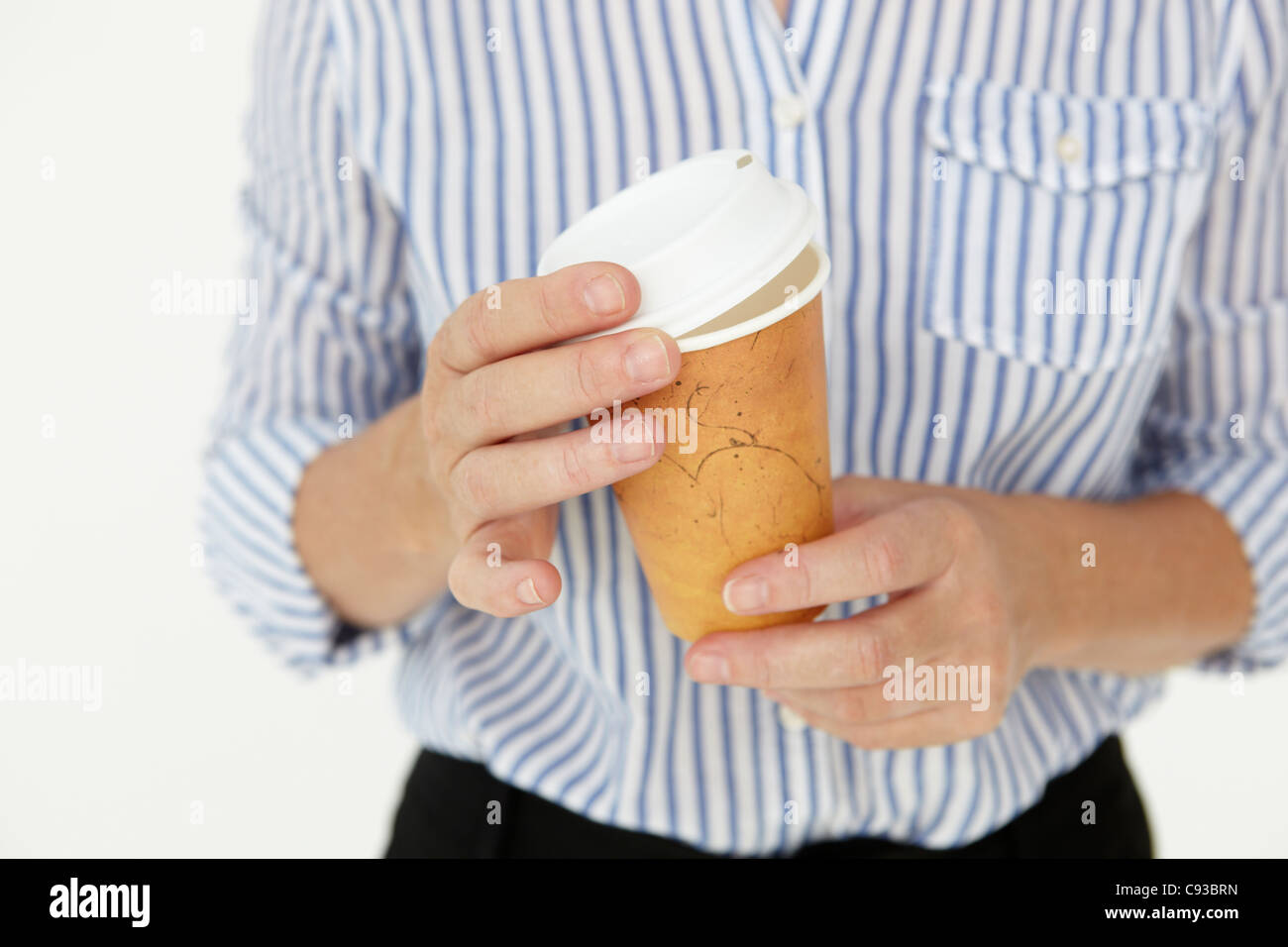 Businesswoman holding takeout coffee Stock Photo