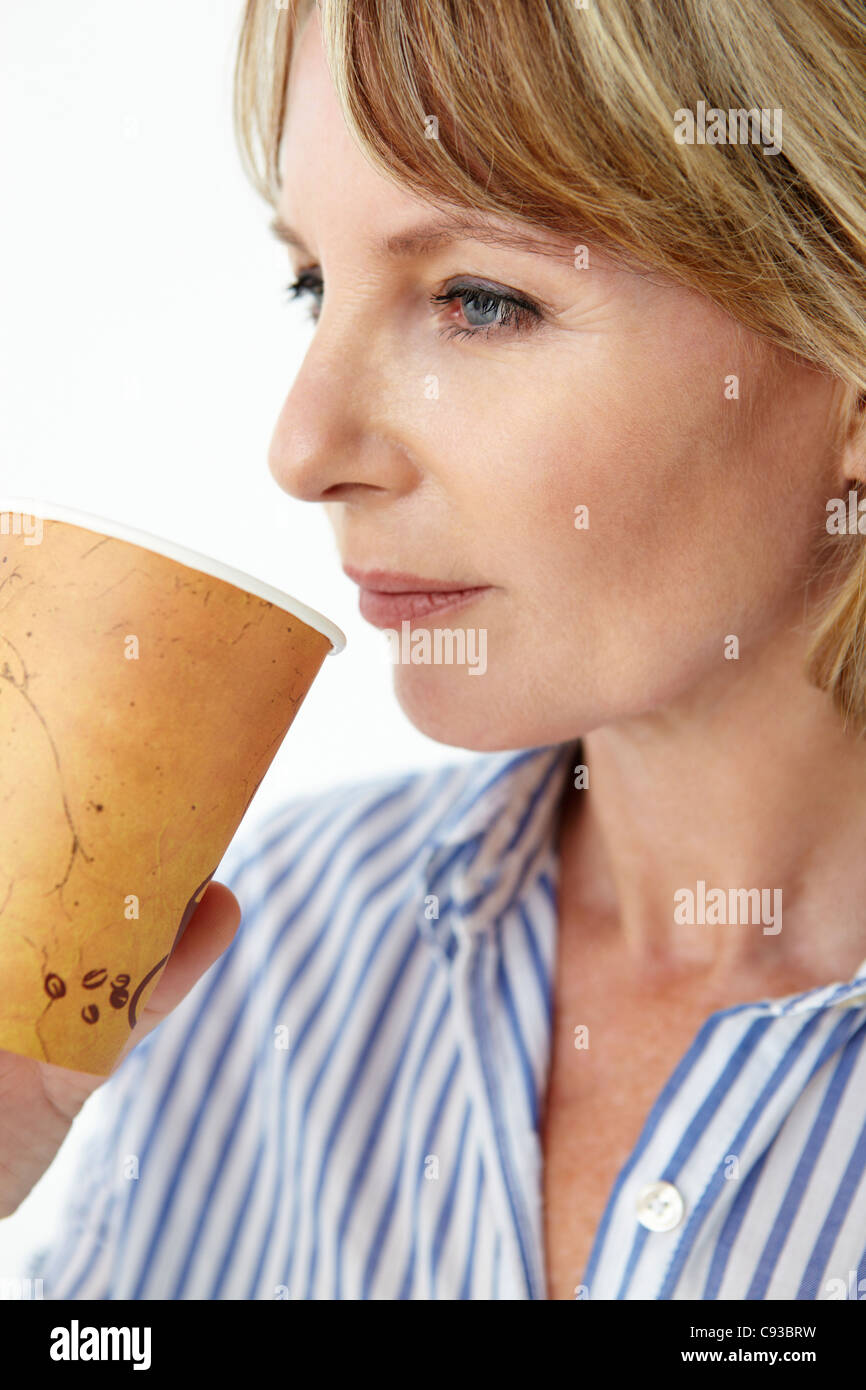Businesswoman drinking takeout coffee Stock Photo