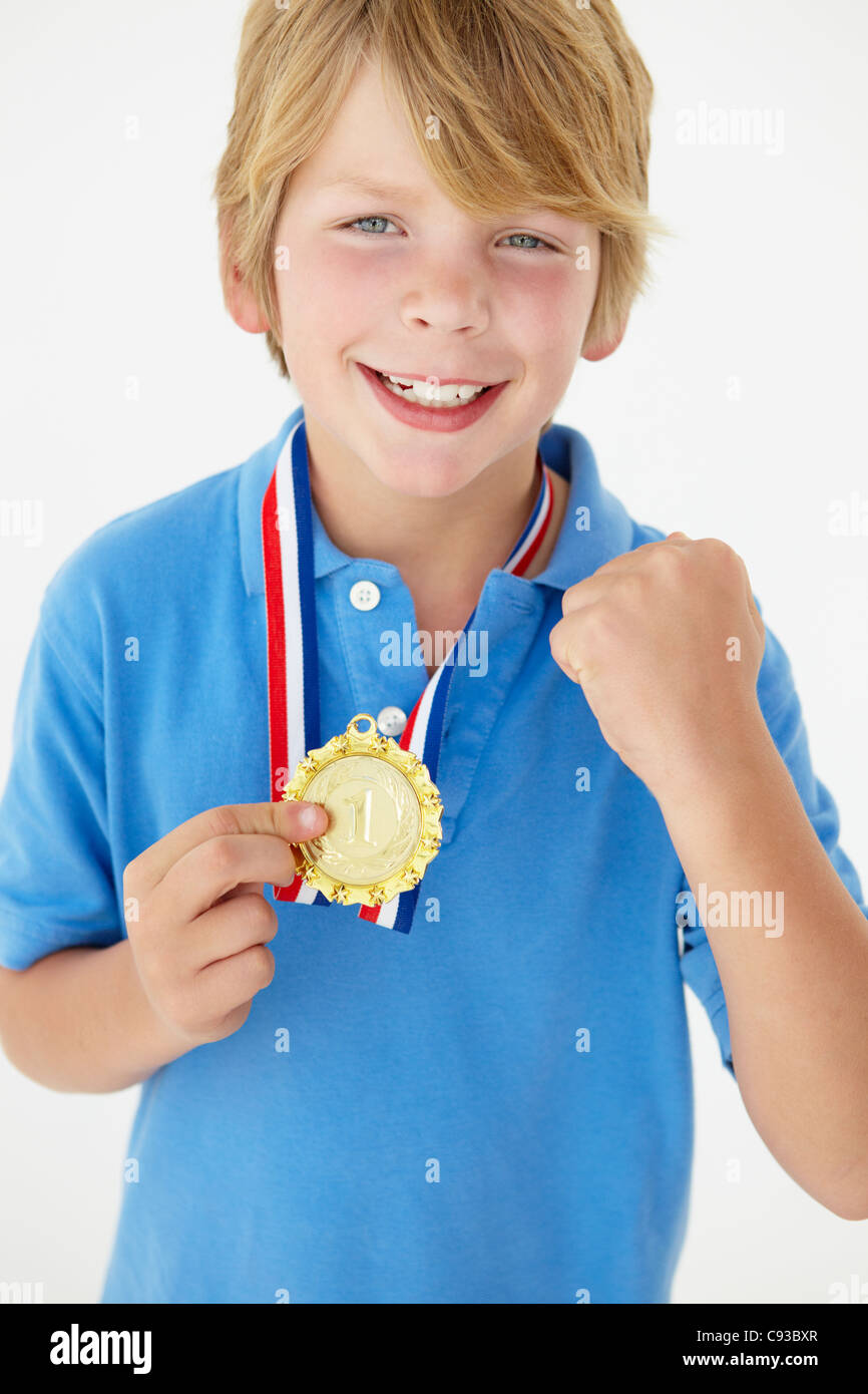 Young boy showing off medal Stock Photo