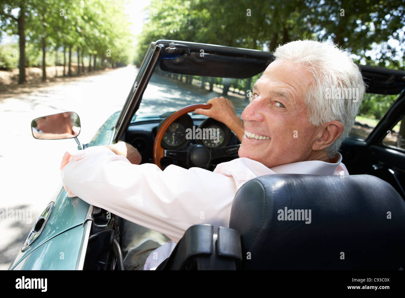 Senior man in sports car Stock Photo