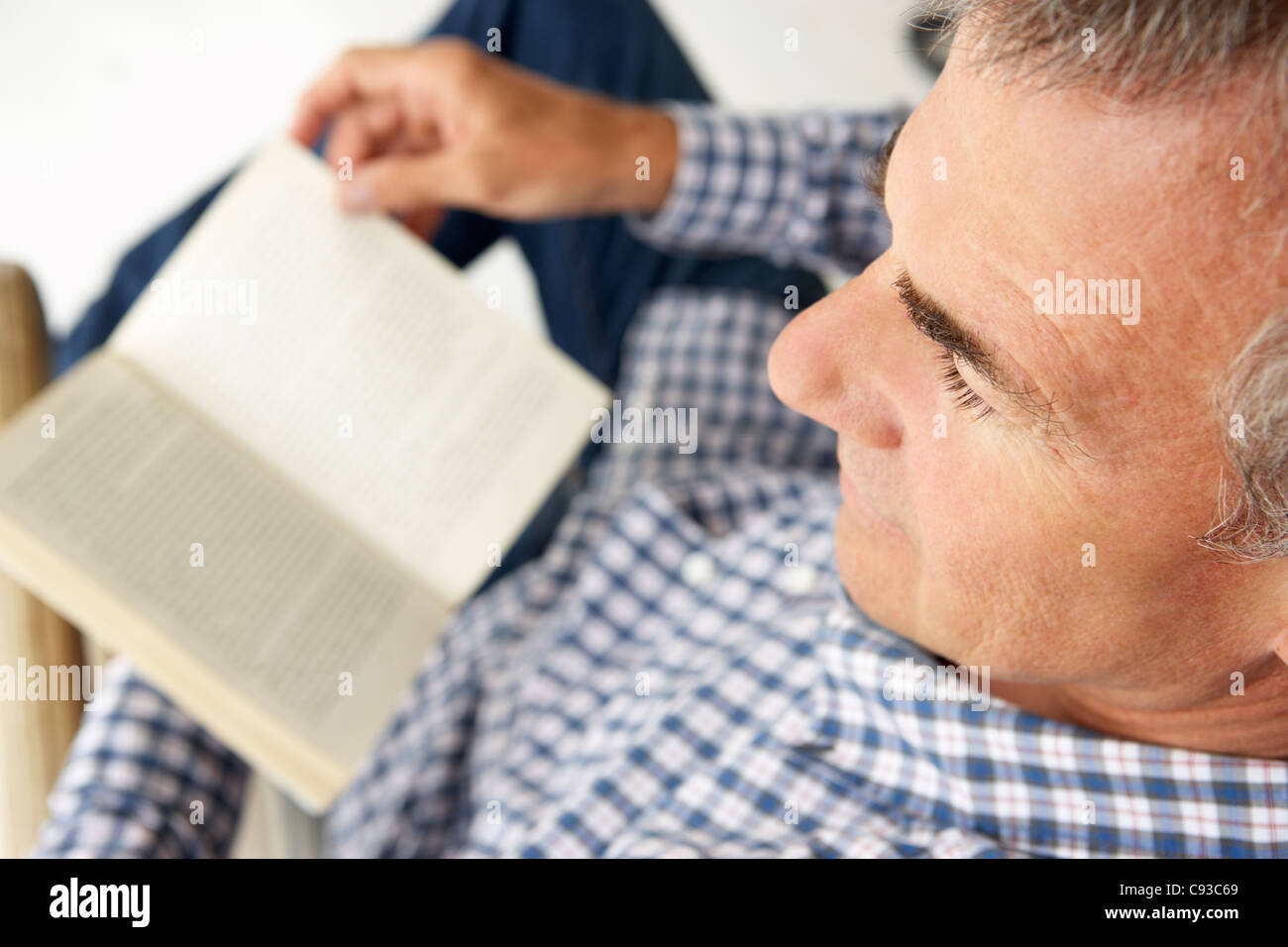 Mid age man reading a book Stock Photo
