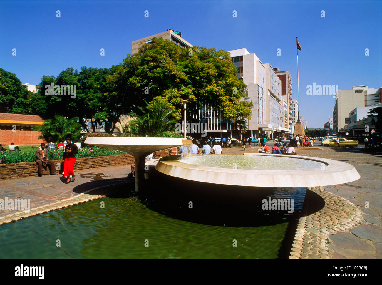 Street scene with sidewalk and water fountain in Harare City in