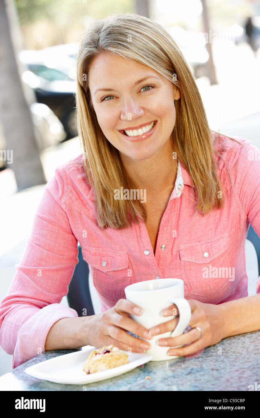 Woman sitting at sidewalk cafÃ© Stock Photo