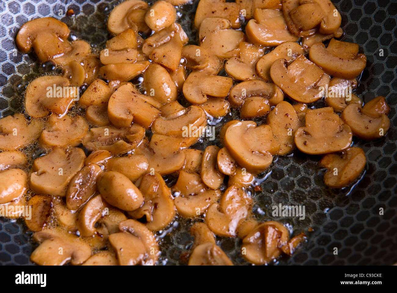 Grinded mushrooms champignon roasting in pan Stock Photo Alamy