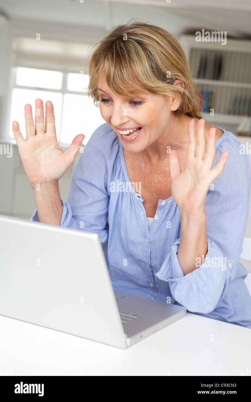 Mid age woman using laptop Stock Photo