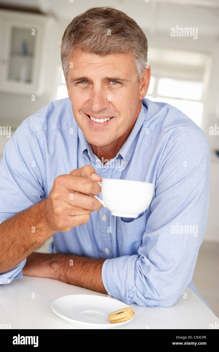 Mid age man with coffee at home Stock Photo