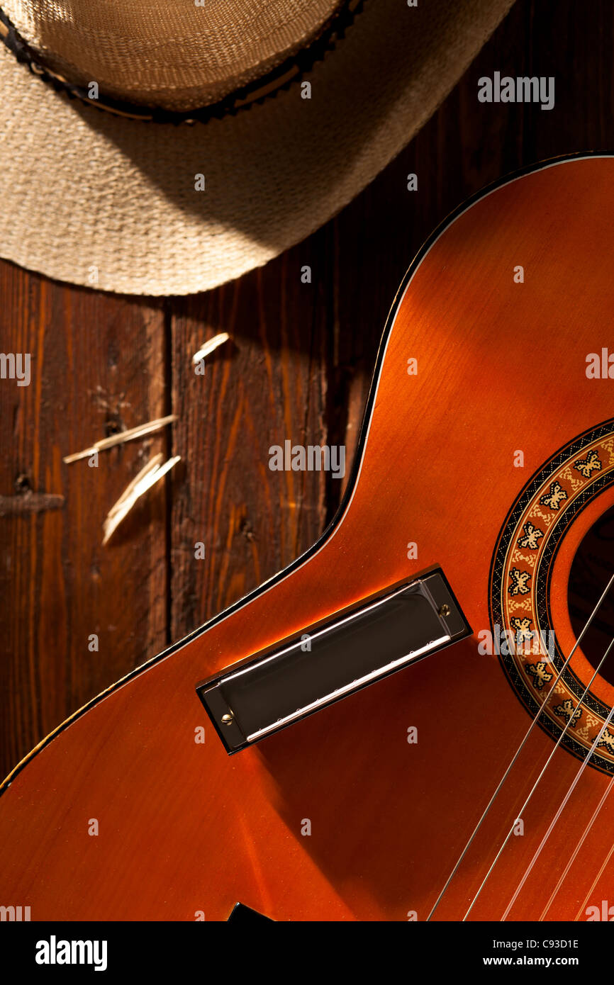 Harmonica on Guitar with Cowboy Hat on Wood Stock Photo