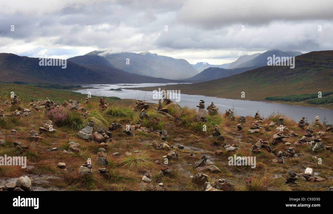 Many Cairns some with messages or letters with memories of loved ones above Loch Loyne, Highland Stock Photo