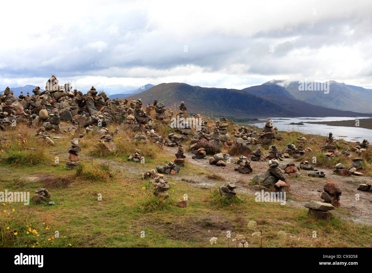 Many Cairns some with messages or letters with memories of loved ones above Loch Loyne, Highland Stock Photo
