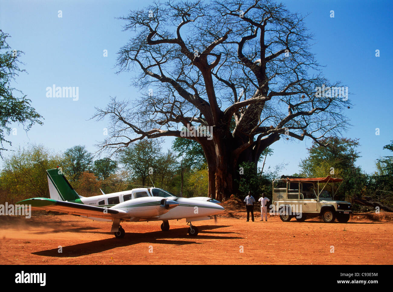 Couple with private airplane landing on dirt air field at Tiger Bay ...