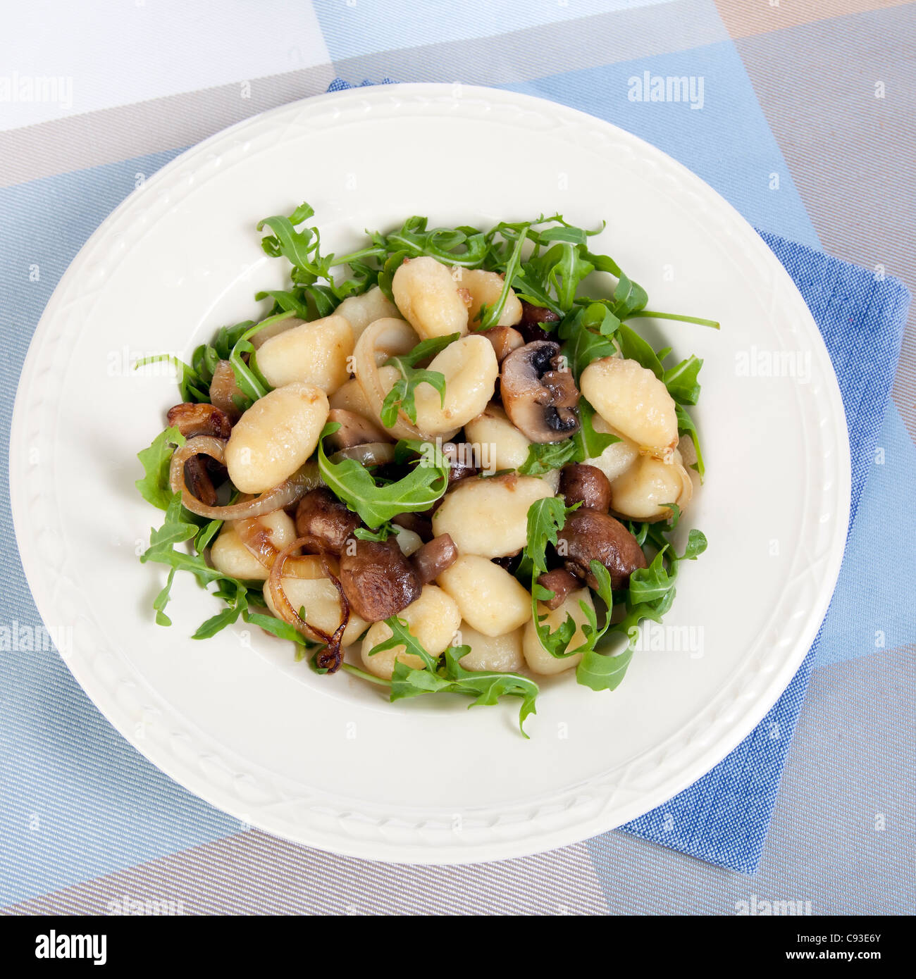 Fresh gnocchi with mushrooms, onions and fresh arugula Stock Photo Alamy