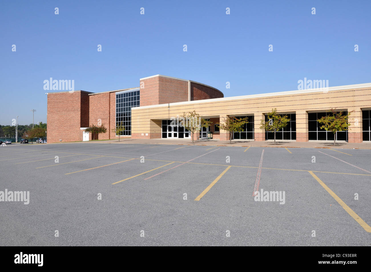 Large empty macadam parking lot by a modern school building Stock Photo