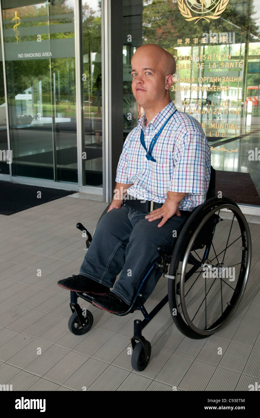 Dr Tom Shakespeare outside the World Health Organisation in Geneva- full body shot showing wheelchair Stock Photo